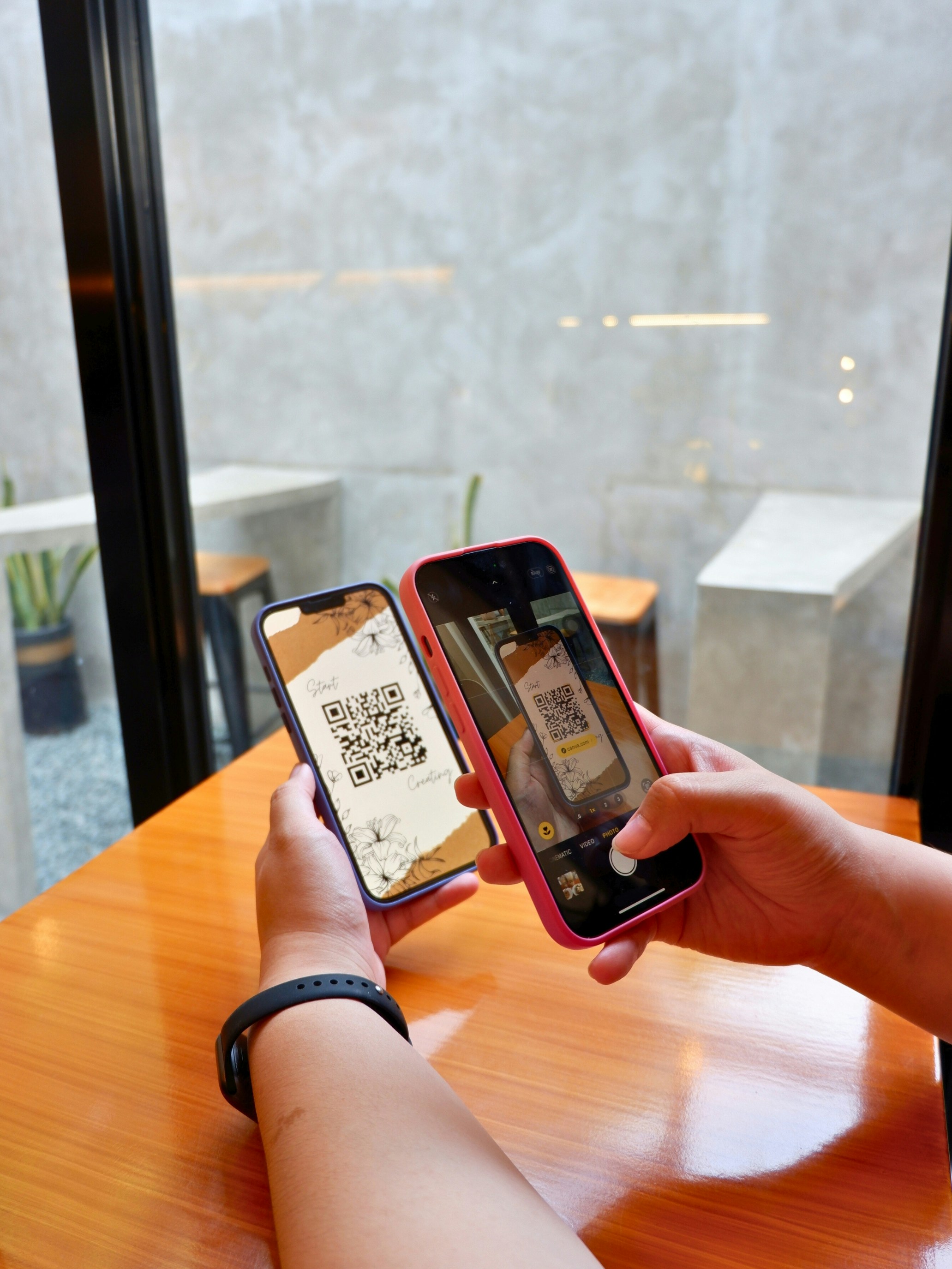 A printed memorial card with a QR code beside a candle