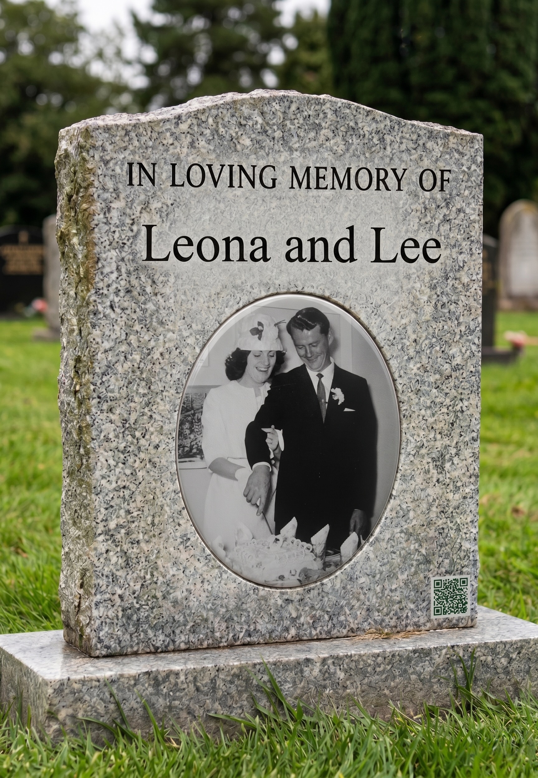 A close-up of a QR code engraved into a granite headstone